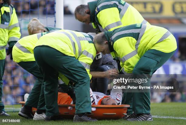 Blackpool's Gary Taylor-Fletcher is stretchered off following a collision with Everton goalkeeper Tim Howard