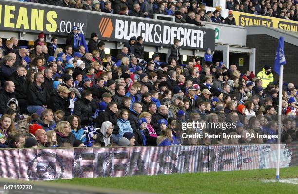 Fans sit behind an advertising board displaying EA's FIFA Street