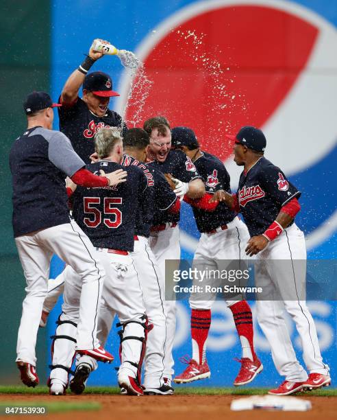 Jay Bruce of the Cleveland Indians celebrates with teammates after hitting a game winning single off Brandon Maurer of the Kansas City Royals during...