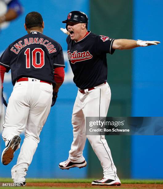 Jay Bruce of the Cleveland Indians celebrates wirh Edwin Encarnacion after hitting a game winning single off Brandon Maurer of the Kansas City Royals...