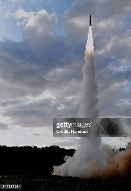 In this handout photo released by the South Korean Defense Ministry, South Korea's missile system firing Hyunmu-2 firing a missile into the East Sea...