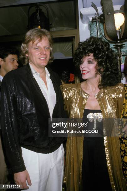 Peter Holm, Joan Collins at party on May 3, 1986 in Saint Tropez, France.