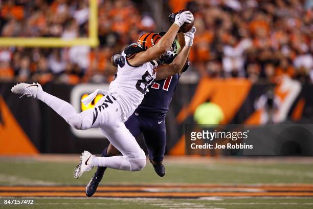 Tyler Eifert of the Cincinnati Bengals makes a catch defended by Marcus Gilchrist of the Houston Texans during the second half at Paul Brown Stadium...