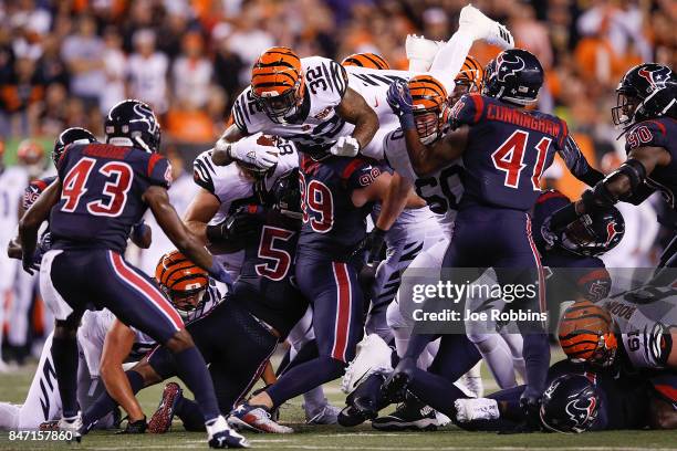 Jeremy Hill of the Cincinnati Bengals jumps over the pile for a first down against the Houston Texans during the second half at Paul Brown Stadium on...