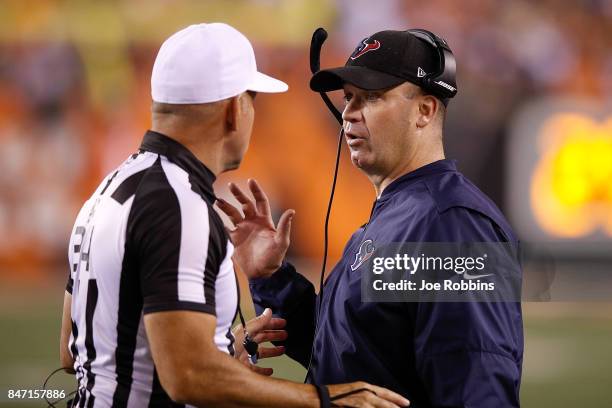 Head coach Bill O'Brien of the Houston Texans talks with referee Clete Blakeman against the Cincinnati Bengals during the second half at Paul Brown...