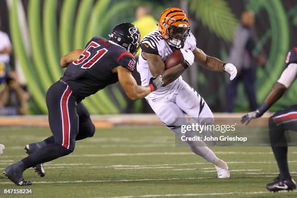 Jeremy Hill of the Cincinnati Bengals runs with the ball defended by Dylan Cole of the Houston Texans during the second half at Paul Brown Stadium on...