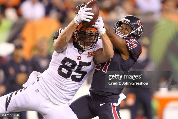 Tyler Eifert of the Cincinnati Bengals makes a catch defended by Marcus Gilchrist of the Houston Texans during the second half at Paul Brown Stadium...