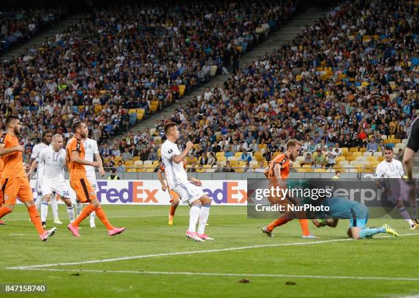 Goalkeeper Orges Shehi of Skenderbeu and Skenderbeu's Gledi Mici save against Dynamo's Yevhen Khacheridi during the UEFA Europa League Group B...