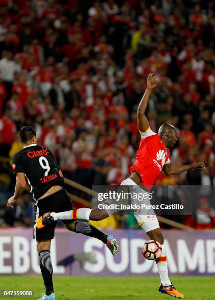 Javier Lopez of Santa Fe and Oscar Cardozo of Libertad compete for the ball during a second leg match between Independiente Santa Fe and Libertad as...
