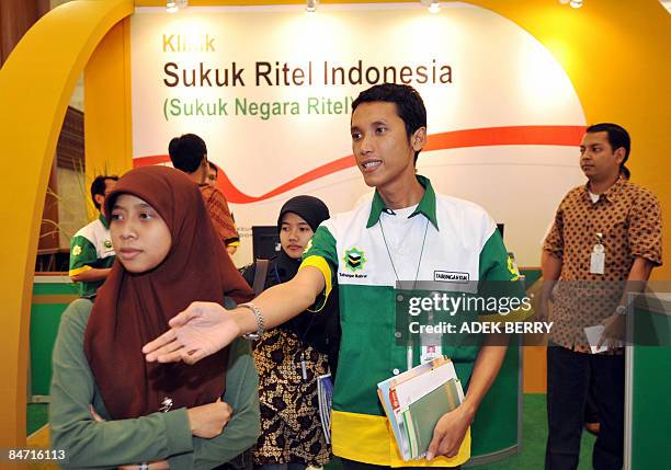 By Stephen Coates An Indonesian bank employee ushers a visitor searching information about sukuk during an exhibition in Jakarta February 6, 2009....