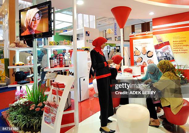 By Stephen Coates Visitors fill brochures during the Sharia Finance Exhibition in Jakarta February 6, 2009. Indonesia launched its first retail...