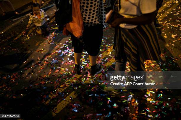 Confetti covers the ground after the grand opening of Chinese artist Cai Guo-Qiang's latest work "Fireflies" in Philadelphia, PA, on September 14,...