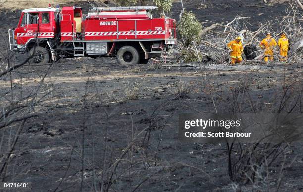 Firefighters dampen down spot fires following the devastating bush fires on February 10, 2009 in Bendigo, Australia. Victorian Police have revised...