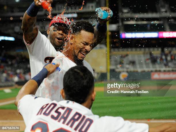 Kennys Vargas and Eddie Rosario of the Minnesota Twins congratulates teammate Byron Buxton on a walk-off solo home run against the Toronto Blue Jays...
