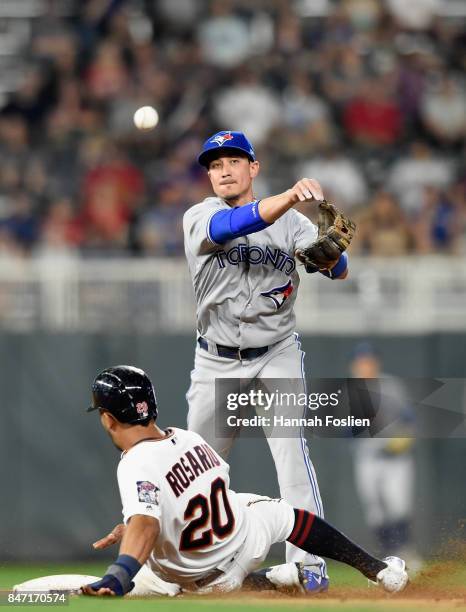 Eddie Rosario of the Minnesota Twins is out at second base as Darwin Barney of the Toronto Blue Jays turns the double play during the eighth inning...