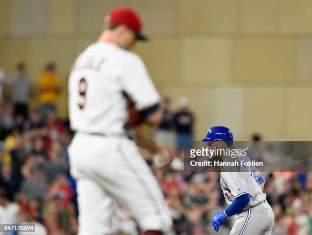 Matt Belisle of the Minnesota Twins looks on as Justin Smoak of the Toronto Blue Jays rounds the bases after hitting a solo home run during the ninth...