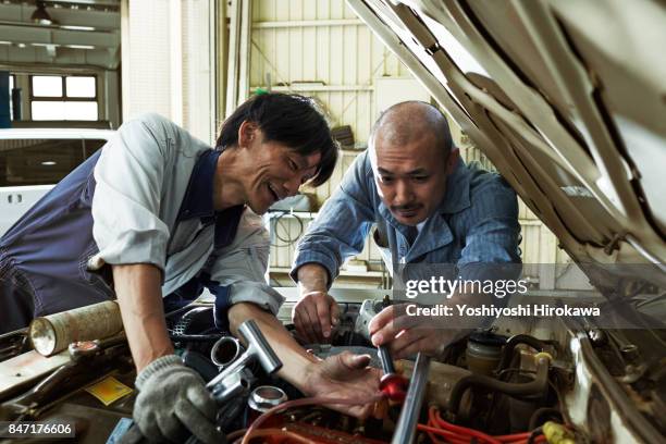 mechanic working sincerely at a japanese automobile repair shop - car passion stock pictures, royalty-free photos & images