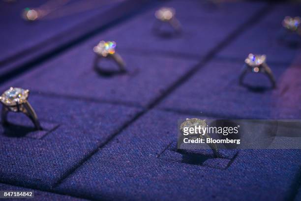 Diamond rings are displayed in a cabinet inside a De Beers SA store in Hong Kong, China, on Thursday, Sept. 14, 2017. Chinese deluxe spending on...