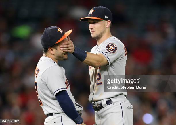 Third baseman Alex Bregman of the Houston Astros covers the eyes of second baseman Jose Altuve as they have playful moment during a pitching change...