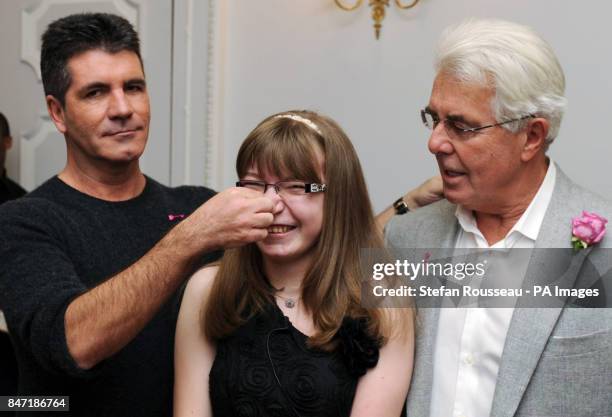 Simon Cowell and publicist Max Clifford meet 16 year old Sian Tolfree at a tea party in aid of the children's hospice charity Shooting Star Chase at...