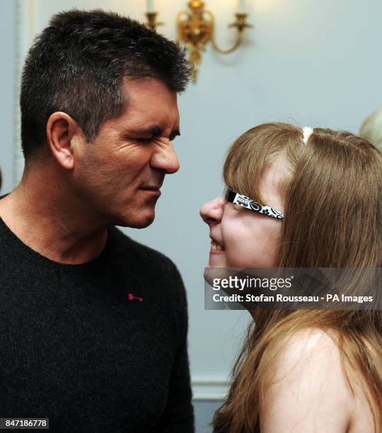 Simon Cowell meets 16 year old Sian Tolfree at a tea party in aid of the children's hospice charity Shooting Star Chase at the Dorchester Hotel in...