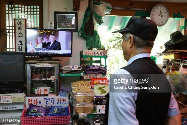 South Korean watches a television broadcast reporting the North Korean missile launch at the their store, near the demilitarized zone of Panmunjom on...