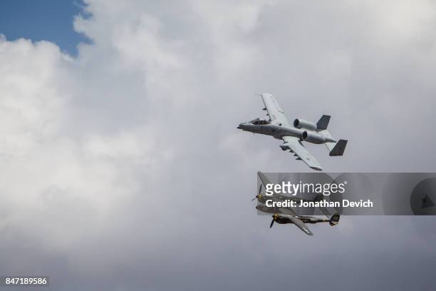 An A-10 Thunderbolt II flies next to a WWII P-38 Lightening at the Reno Championship Air Races on September 14, 2017 in Reno, Nevada.
