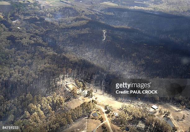 Burnt out houses and sheds lie in ruins after a wildfire raced up from farmland below near Bunyip in the latrobe Valley, some 100km east of Melbourne...