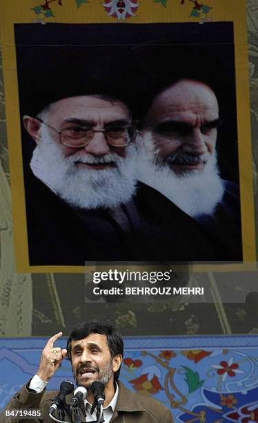 Iranian President Mahmoud Ahmadinejad adresses the crowd under portraits of Iran's supreme leader, Ayatollah Ali Khamenei and Iran's late founder of...