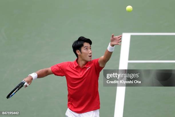 Yuichi Sugita of Japan serves in his singles match against Guilherme Clezar of Brazil during day one of the Davis Cup World Group Play-off between...