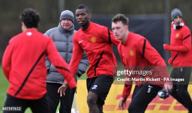 Manchester United manager Sir Alex Ferguson watches his players during a training session at Carrington Training Centre, Manchester.