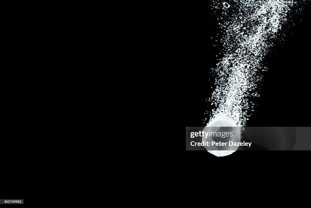 Pill dissolving in water.