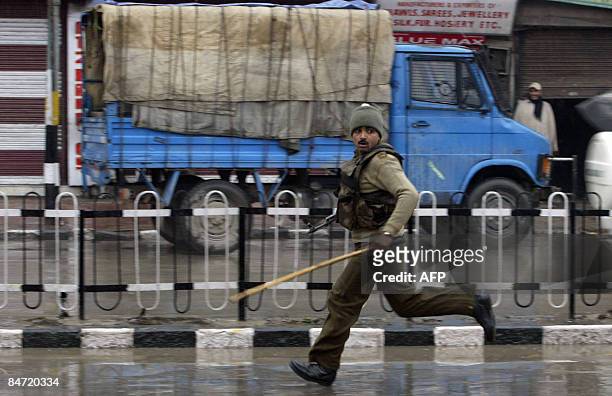 Central Reserve Police Force soldier runs along a street during a demonstration in Srinagar on February 10, 2009. Security forces opened fire and...