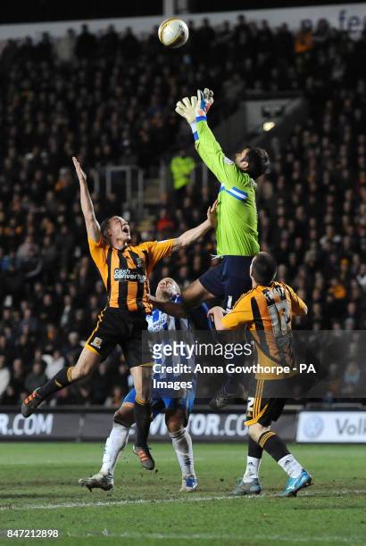 Brighton & Hove Albion goalkeeper beats Hull City's James Chester to the ball during the npower Football League Championship match at the KC Stadium,...