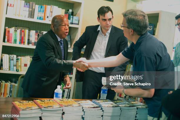 American politician and Civil Rights activist US Representative John Lewis shakes hands with unidentified man at a book signing during the Montreat...