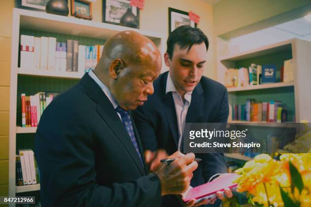 American politician and Civil Rights activist US Representative John Lewis and fellow politician and co-writer Andrew Aydin sign a book during the...