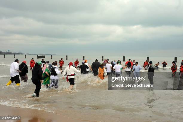 View of participants in a Chicago Polar Plunge event as they run into Lake Michigan , Chicago, Illinois, 2010.