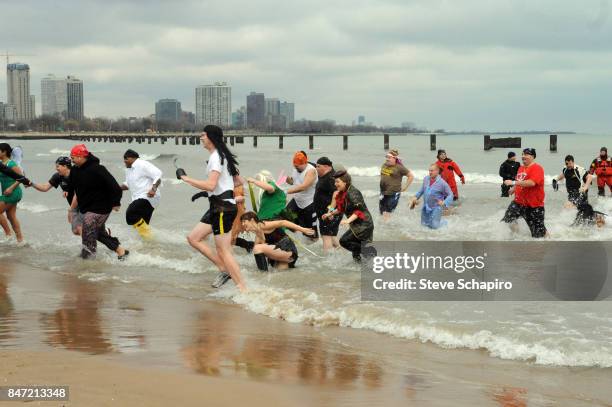 View of participants in a Chicago Polar Plunge event as they run out of Lake Michigan , Chicago, Illinois, 2010.