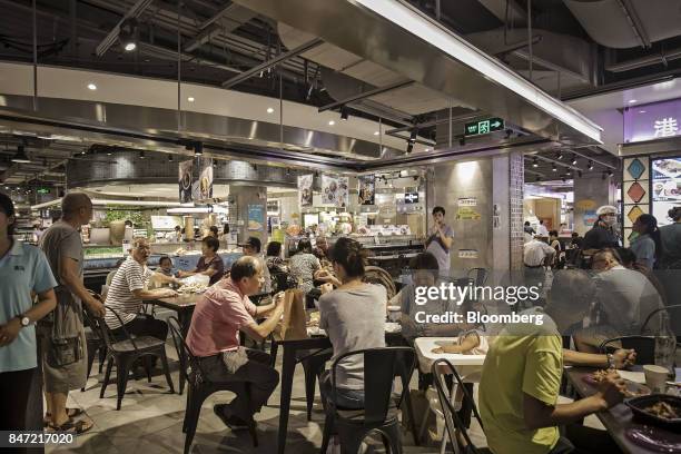 Customers dine at a restaurant inside an Alibaba Group Holding Ltd. Hema Store in Shanghai, China, on Tuesday, Sept. 12, 2017. Hema stores are...