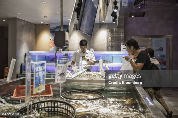 Customers select live seafood at an Alibaba Group Holding Ltd. Hema Store in Shanghai, China, on Tuesday, Sept. 12, 2017. Hema stores are one-stop...
