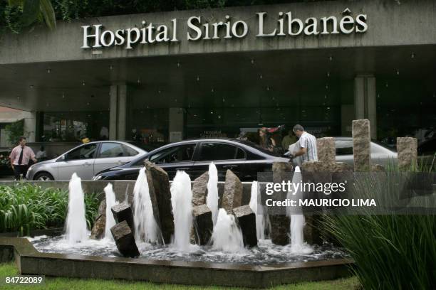 People leave their vehicles at a valet parking service, at the main entrance of the Sirio-Libanes Hospital, in Sao Paulo, Brazil, on February 10,...