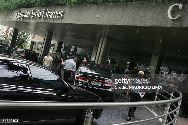 People leave their vehicles at a valet parking service, at the main entrance of the Sirio-Libanes Hospital, in Sao Paulo, Brazil, on February 10,...