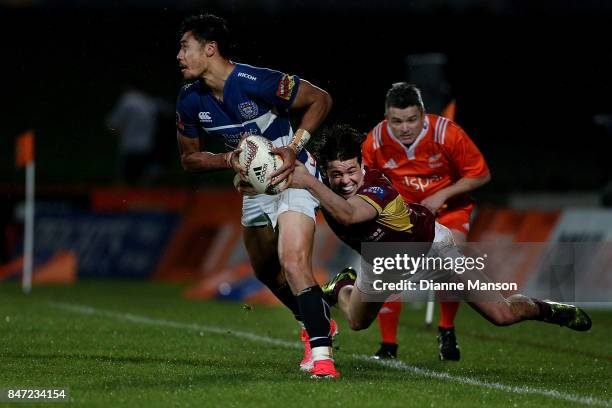 Melani Nanai of Auckland is tackled by Mike Molloy of Southland during the round five Mitre 10 match between Southland and Auckland at Rugby Park...