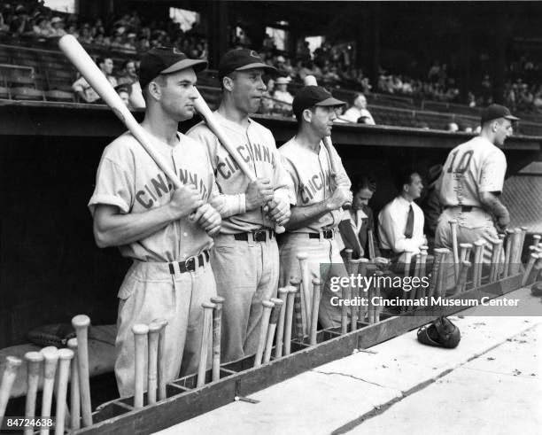 Portrait of the Cincinnati Reds outfield standing in the dugout, from left, centerfielder Harry Craft, left fielder Wally Berger, and right fielder...