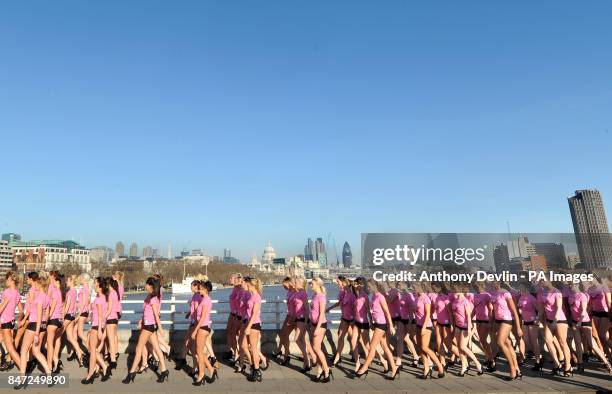 The City of London including St Paul's Cathedral is seen in the background as 100 girls wearing hot pants walk across Waterloo Bridge in central...