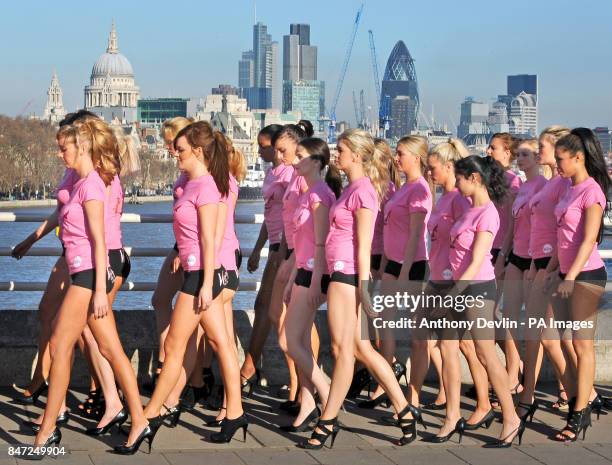 The City of London including St Paul's Cathedral is seen in the background as 100 girls wearing hot pants walk across Waterloo Bridge in central...