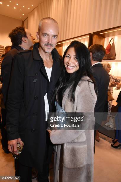 Anggun and her husband Olivier Maury attend the Loewe Cocktail As part of "La Fete Des Vendanges" At Avenue Montaigne on September 14, 2017 in Paris,...