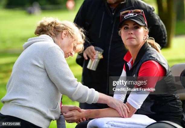 Paula Creamer of USA gets physio treatment for her sprained wrist during the weather delayed first round of The Evina Championship at Evian Resort...