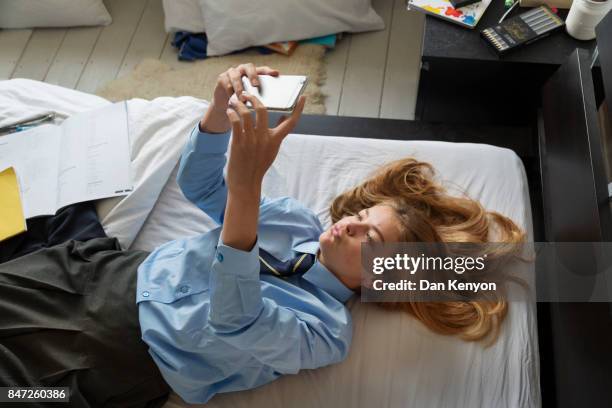 teenage girl aged 14 in bedroom - girl in her bed stock pictures, royalty-free photos & images