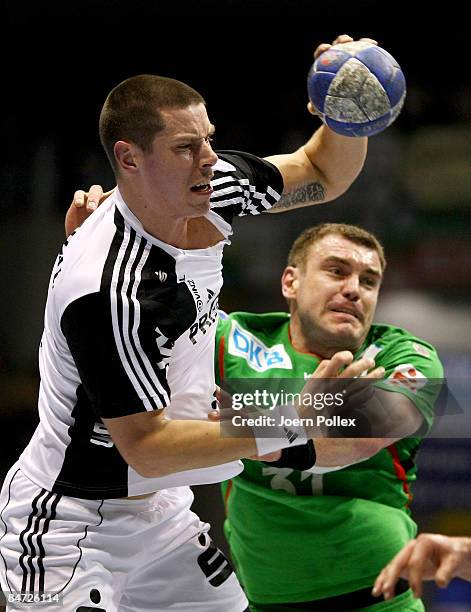 Kim Andersson of Kiel is attacked by Bartosz Jurecki of Magdeburg during the Toyota Handball Bundesliga match between SC Magdeburg and THW Kiel at...